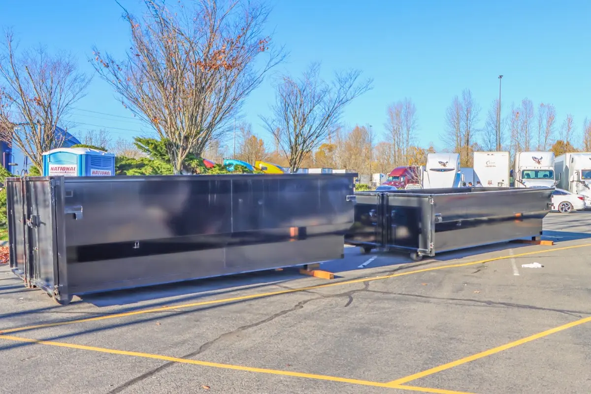 Professional dumpster rental service with roll-off container on residential driveway in Loma Linda